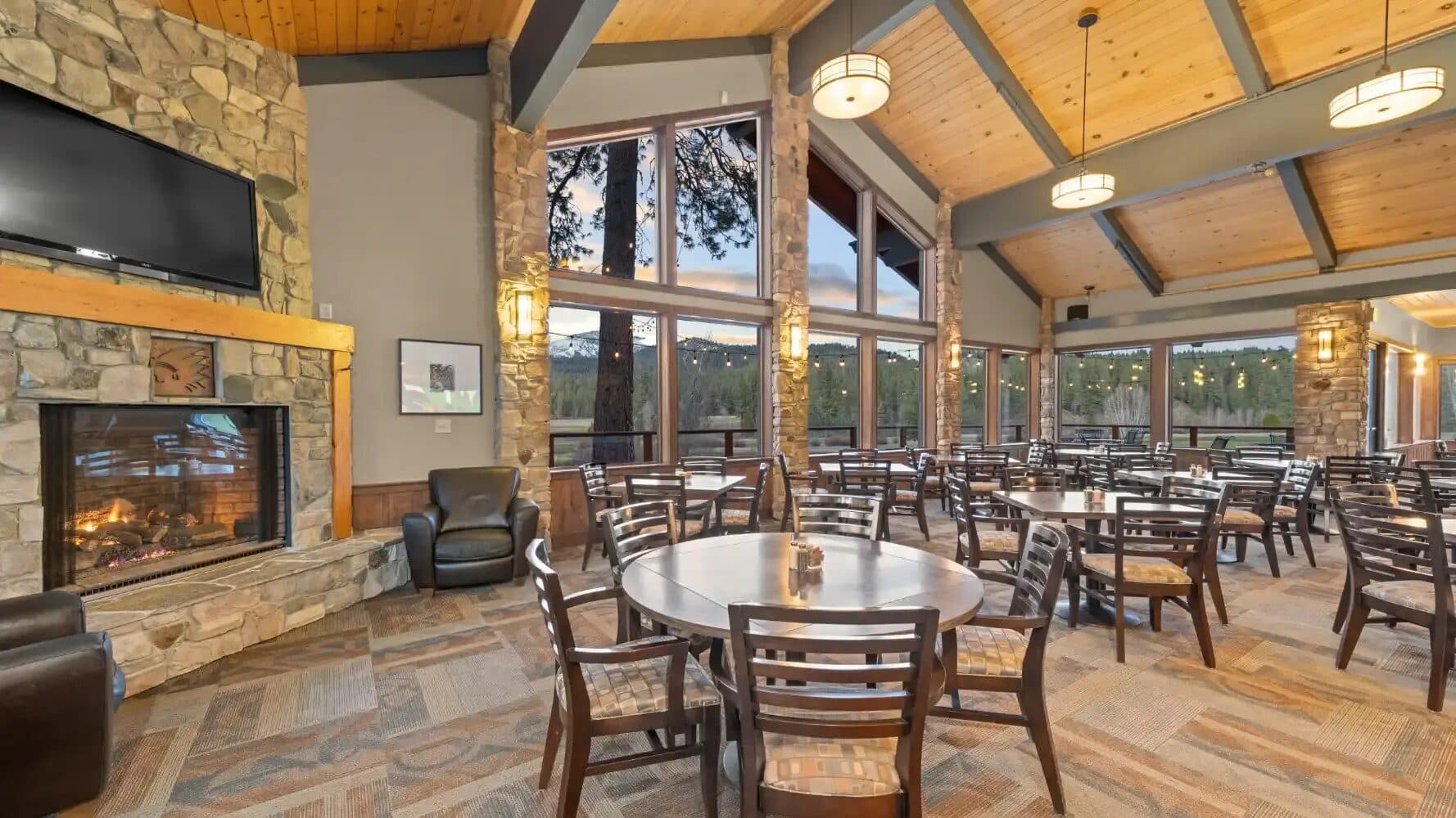 Graeagle Meadows clubhouse interior with fireplace and mountain views Graeagle Meadows clubhouse interior with fireplace and mountain views