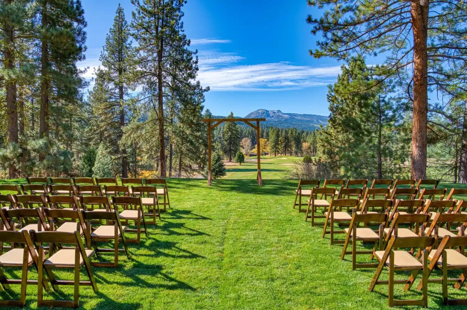 Wedding ceremony setup at Graeagle Meadows with Sierra pine forest backdrop Wedding ceremony setup at Graeagle Meadows with Sierra pine forest backdrop