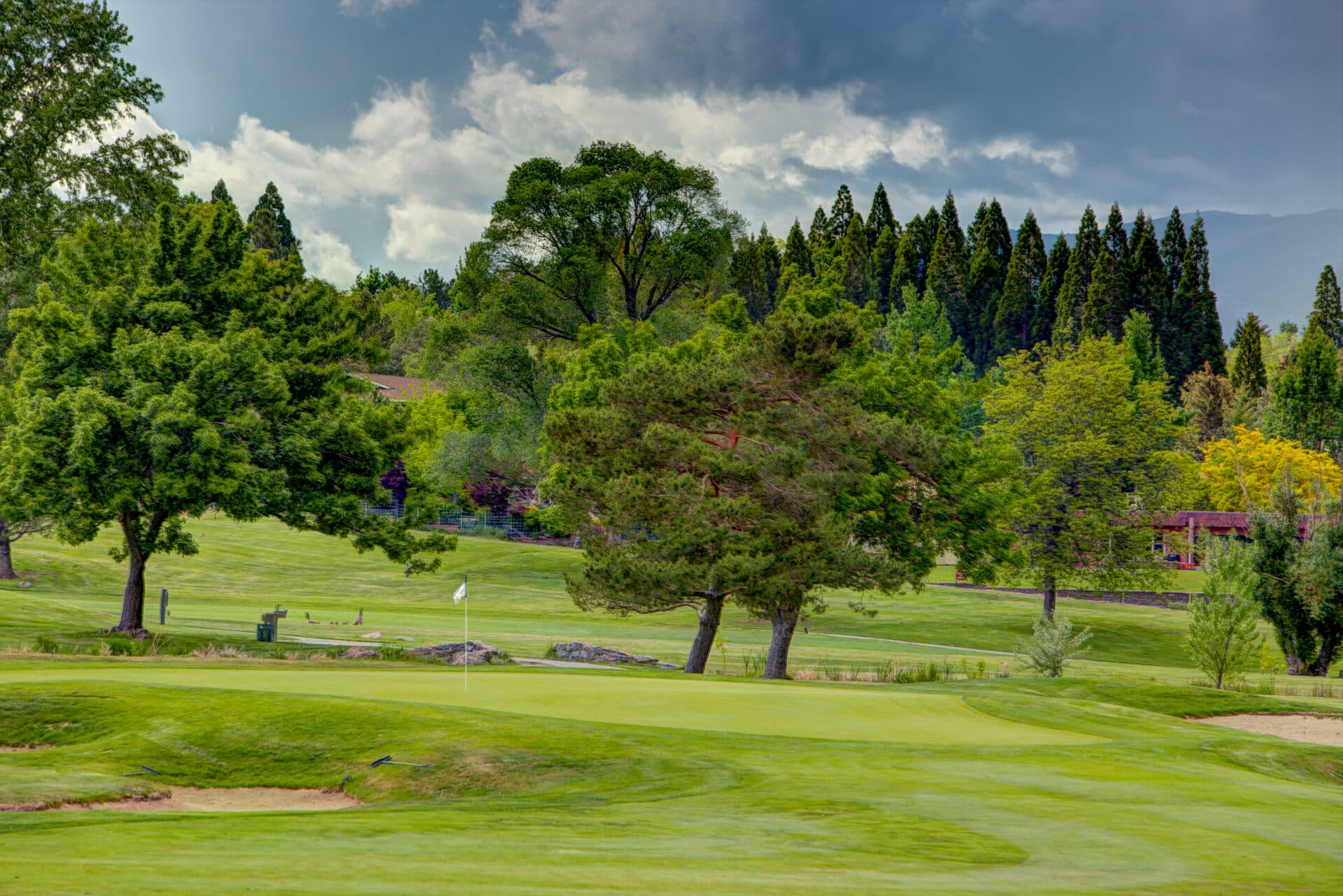 LakeRidge Golf Course panoramic view with island green, Truckee River, and Reno skyline at dusk LakeRidge Golf Course panoramic view with island green, Truckee River, and Reno skyline at dusk