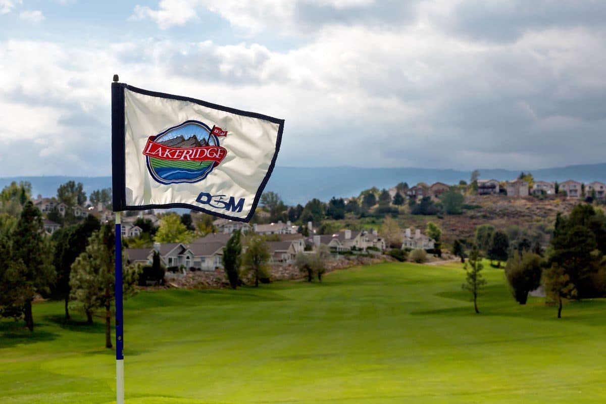 LakeRidge Golf Course flagstick with branded flag overlooking Reno skyline LakeRidge Golf Course flagstick with branded flag overlooking Reno skyline