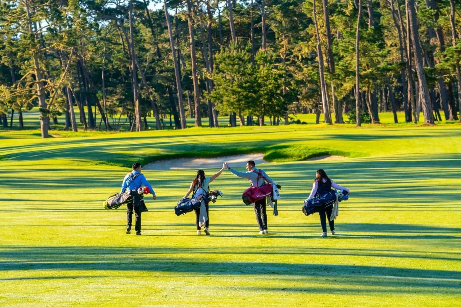 Golfers walking fairway at Poppy Hills Golf Course Golfers walking fairway at Poppy Hills Golf Course