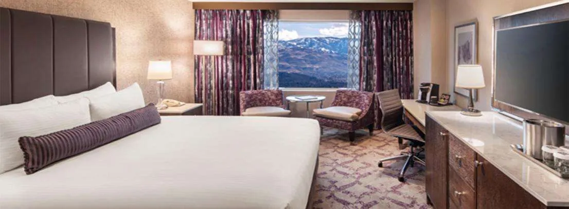 Silver Legacy Players Premium Room – 2 Queen at Silver Legacy Resort Casino — bedroom with premium bedding