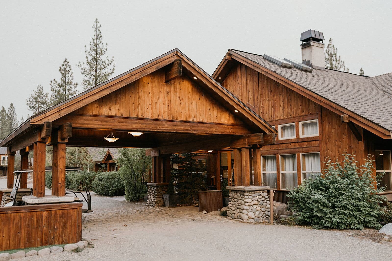 Chalet View Lodge front entrance with wooden architecture and pine trees, Portola CA Chalet View Lodge front entrance with wooden architecture and pine trees, Portola CA