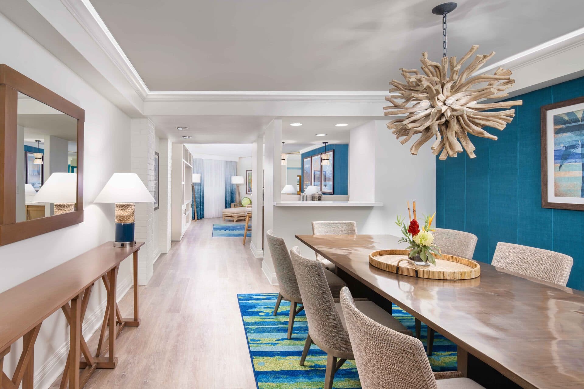 Good Vibes Suite living room with separate sitting area, turquoise accent rug, and coastal-inspired decor at Margaritaville Resort Lake Tahoe