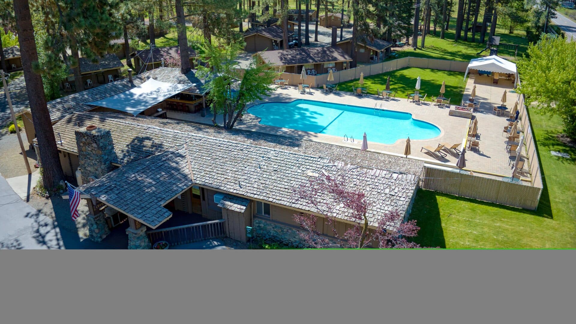 River Pines Resort aerial with Sierra Nevada mountain backdrop and alpine pines