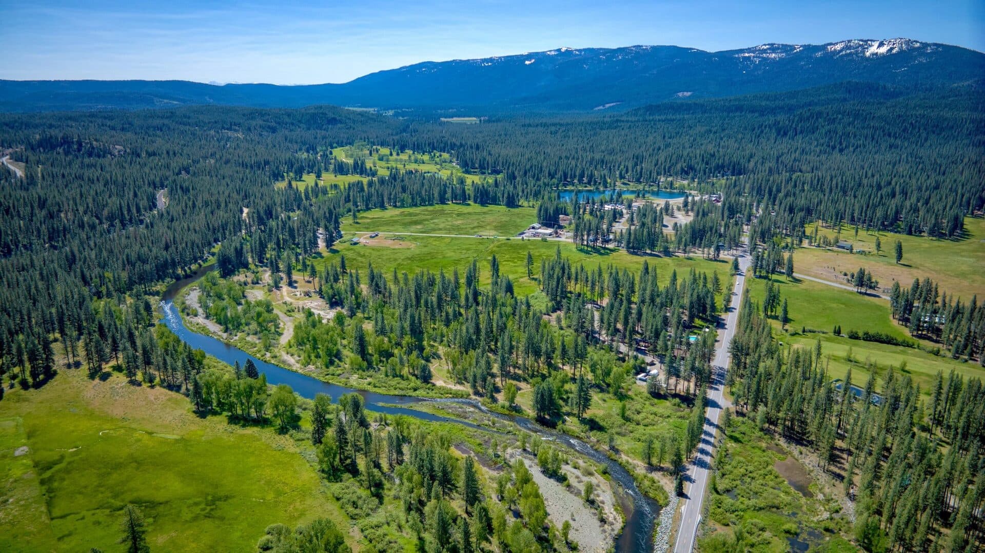River Pines Resort Graeagle — aerial view of the pine-tree resort property with golf course backdrop River Pines Resort Graeagle — aerial view of the pine-tree resort property with golf course backdrop